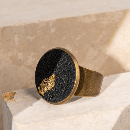 Handcrafted Black Moon Flat Ring made of deep matte black polymer clay with a genuine gold leaf accent, inspired by lunar cycles, shadow and light, and modern celestial jewelry, available at Soul and Sage.